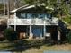 Charming two-story lake house with a spacious deck and brick foundation, perfect for waterfront living at 254 N Shoreline N Dr # 38, New London, NC 28127