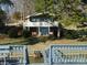 Beautiful lakefront home with inviting upper deck and easy access to the water, surrounded by lush greenery at 254 N Shoreline N Dr # 38, New London, NC 28127