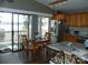Eat-in kitchen featuring stainless steel appliances, wood cabinetry, hardwood floors and island seating at 254 N Shoreline N Dr # 38, New London, NC 28127