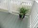 Detail of the porch flooring and railing, with a potted plant in patriotic pot at 254 N Shoreline N Dr # 38, New London, NC 28127