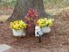 Outdoor flower pots with yellow flowers and a dog statue in front of a tree at 254 N Shoreline N Dr # 38, New London, NC 28127