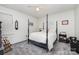 Bedroom with a four poster bed, carpeted floor and simple decoration at 2542 Clearkirk Ct, Matthews, NC 28105