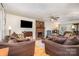 Spacious living room features a brick fireplace, hardwood floors, and comfortable seating at 2542 Clearkirk Ct, Matthews, NC 28105