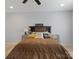 Cozy bedroom featuring neutral walls, a comfortable bed, and a decorative headboard at 28926 Hartsell Rd, Albemarle, NC 28001