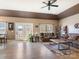 Bright living room with hardwood floors, ceiling fan, and large windows providing natural light at 28926 Hartsell Rd, Albemarle, NC 28001