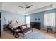 Inviting bedroom featuring a tray ceiling, comfortable furniture, and large windows at 3216 Bridgewick Rd, Waxhaw, NC 28173