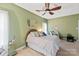 Cozy bedroom featuring a ceiling fan, a comfortable bed, and natural light at 3216 Bridgewick Rd, Waxhaw, NC 28173