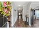 Elegant foyer with hardwood floors, neutral paint, arched doorway, and decorative wreath on front door at 3216 Bridgewick Rd, Waxhaw, NC 28173