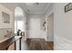 Bright and airy foyer with hardwood floors, white trim, arched doorway, and a view of the front door at 3216 Bridgewick Rd, Waxhaw, NC 28173