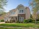 Inviting two-story home with stone details, a covered porch, an attached two-car garage, and a well-maintained lawn at 3216 Bridgewick Rd, Waxhaw, NC 28173