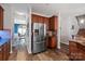 Spacious kitchen with stainless steel refrigerator and adjacent dining room at 3216 Bridgewick Rd, Waxhaw, NC 28173