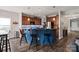 Kitchen island with bar seating, wood cabinets, and stylish pendant lighting at 3216 Bridgewick Rd, Waxhaw, NC 28173