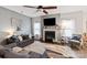 Bright living room showcasing a fireplace, ceiling fan, and ample natural light at 3216 Bridgewick Rd, Waxhaw, NC 28173
