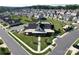 Aerial view of community clubhouse with manicured lawn and parking at 4023 Gozzi Dr, Iron Station, NC 28080