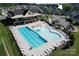 Community clubhouse and pool aerial view with lounge chairs, tables, and a playground at 4023 Gozzi Dr, Iron Station, NC 28080