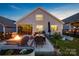 Relaxing backyard features a fire pit and outdoor dining area, perfect for entertaining in the evenings at 4023 Gozzi Dr, Iron Station, NC 28080