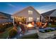 An outdoor backyard features a stone fire pit surrounded by Adirondack chairs at 4023 Gozzi Dr, Iron Station, NC 28080