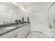 Well-lit bathroom with granite countertops, dual sinks, and a glass-enclosed shower at 4023 Gozzi Dr, Iron Station, NC 28080