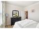 Bright bedroom featuring a black dresser, stylish mirror, and natural light from the window at 4023 Gozzi Dr, Iron Station, NC 28080