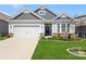 Well-maintained home displaying a manicured lawn, lush landscaping, and an attached garage, creating curb appeal at 4023 Gozzi Dr, Iron Station, NC 28080