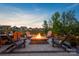 Relaxing outdoor area with a cozy stone fire pit and comfortable Adirondack chairs at 4023 Gozzi Dr, Iron Station, NC 28080