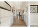 Bright and inviting foyer featuring hardwood floors, white molding, and views into the dining area at 4023 Gozzi Dr, Iron Station, NC 28080