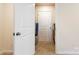 Hallway with carpeted floors, white doors, neutral walls, and accessible storage at 4023 Gozzi Dr, Iron Station, NC 28080