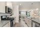Stylish kitchen with granite countertops, stainless steel appliances, and seamless flow into the dining and living spaces at 4023 Gozzi Dr, Iron Station, NC 28080