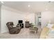 Spacious living room with comfortable recliner chairs, carpeted floors, and warm lighting at 4023 Gozzi Dr, Iron Station, NC 28080
