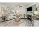 Cozy living room featuring a fireplace, comfortable seating, and lots of natural light at 4023 Gozzi Dr, Iron Station, NC 28080