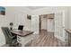 Office with hardwood floors, a desk with drawers, and access to the staircase at 4023 Gozzi Dr, Iron Station, NC 28080