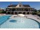Community pool with zero entry fountain and clubhouse in the background at 4023 Gozzi Dr, Iron Station, NC 28080