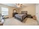 This carpeted bedroom features neutral walls and a ceiling fan to keep you cool on warm days at 4300 Haddington Dr, Fort Mill, SC 29707