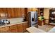 Kitchen featuring stainless steel refrigerator and matching oak cabinetry at 5304 Woodridge Dr, Monroe, NC 28110