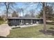 Expansive backyard featuring a patio with outdoor seating and a manicured lawn at 608 Kenlough Dr, Charlotte, NC 28209