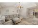 Inviting living room with plush seating, vaulted ceiling, ceiling fan, and wood-look flooring at 6622 Cedar Cliff Dr, Charlotte, NC 28216