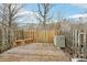 Backyard deck area with a wooden fence, air conditioning unit, and tree at 7344 Pebblestone Dr # E, Charlotte, NC 28212