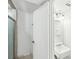 Bright bathroom featuring a vanity, mirror, and shower with glass door at 7344 Pebblestone Dr # E, Charlotte, NC 28212