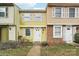 Charming two-story townhouse featuring bright yellow siding and white shutters at 7344 Pebblestone Dr # E, Charlotte, NC 28212