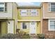 Charming two-story townhouse featuring bright yellow siding and white shutters at 7344 Pebblestone Dr # E, Charlotte, NC 28212