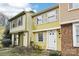 Charming two-story townhouse featuring bright yellow siding and white shutters at 7344 Pebblestone Dr # E, Charlotte, NC 28212