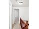 Hallway with wood railing and view of room at the end of the hall at 7344 Pebblestone Dr # E, Charlotte, NC 28212