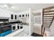 Well-lit kitchen with white cabinets, black countertops, and stainless steel appliances at 7344 Pebblestone Dr # E, Charlotte, NC 28212