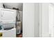 Laundry room featuring a stacked washer and dryer and a hot water heater at 7344 Pebblestone Dr # E, Charlotte, NC 28212