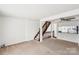 Bright living room with stairs, neutral carpet, and a view of the kitchen at 7344 Pebblestone Dr # E, Charlotte, NC 28212