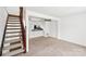 Bright living room with stairs, neutral carpet, and a view of the kitchen at 7344 Pebblestone Dr # E, Charlotte, NC 28212