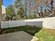 This backyard features a patio and a white picket fence at 7702 Brisbane Ct, Charlotte, NC 28215