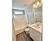 Bathroom featuring white vanity and tiled shower at 7702 Brisbane Ct, Charlotte, NC 28215