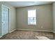 Carpeted bedroom with a window, base trim, and a closet at 7702 Brisbane Ct, Charlotte, NC 28215