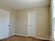 Bedroom featuring carpeted floors, a window, and base trim at 7702 Brisbane Ct, Charlotte, NC 28215
